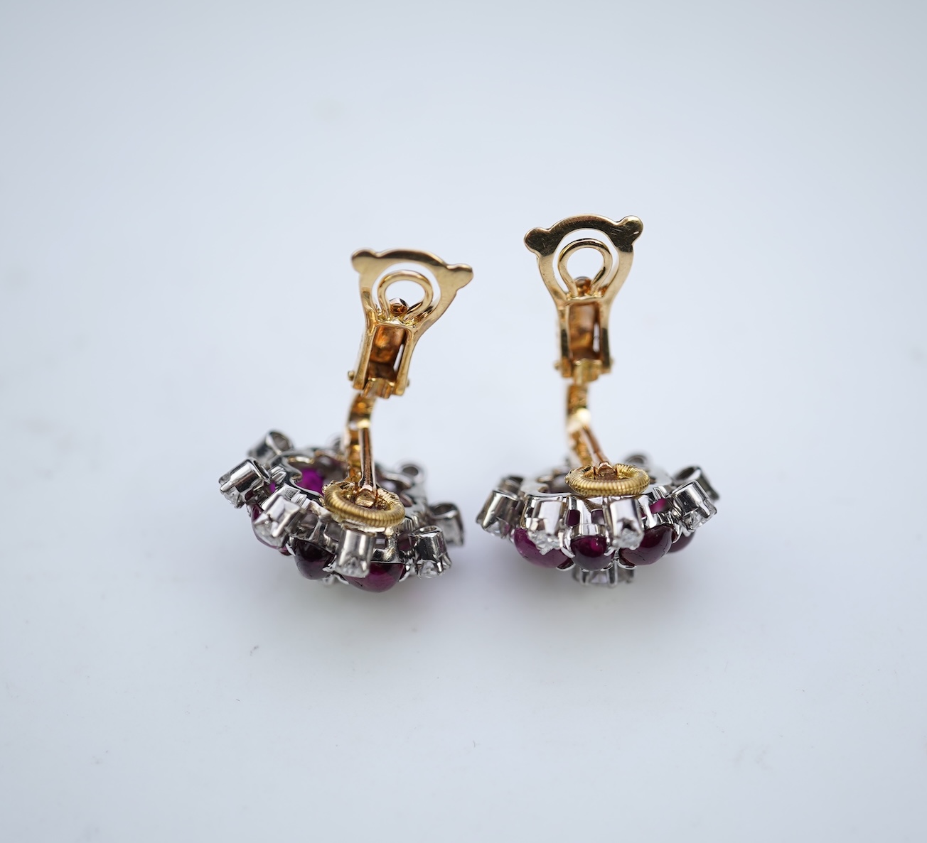 A pair of ruby and diamond ear clips, mid 20th century